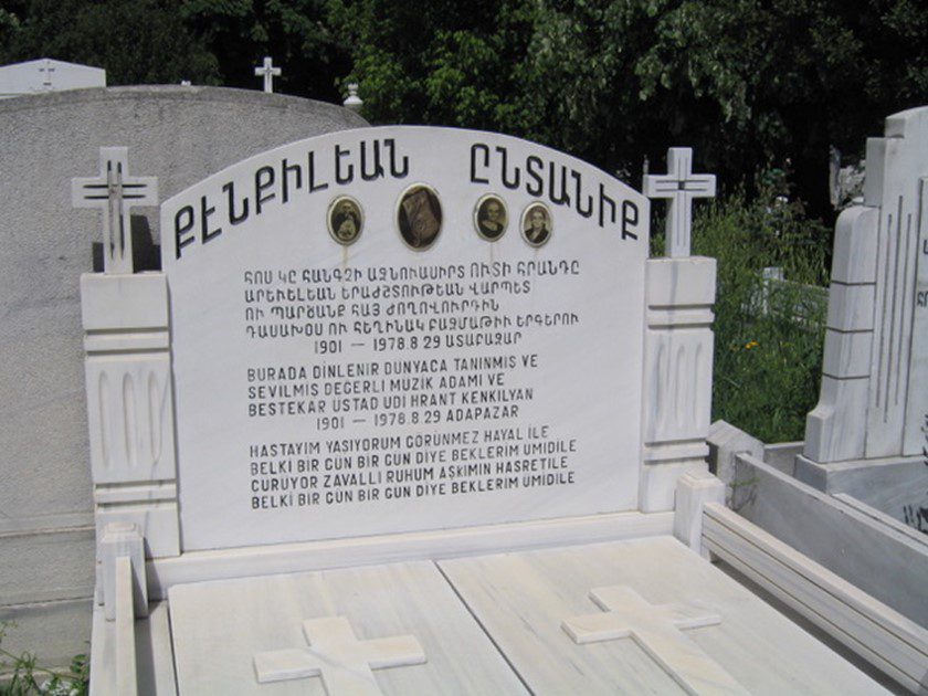 A white grave with crosses and the names of people.